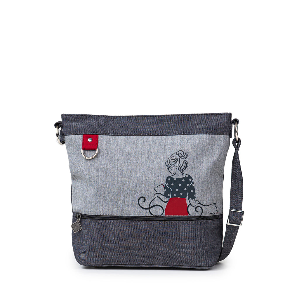 The Jak's Fantasia Corse bag features a top zip main compartment and front zip pocket. This bag is great for organizing your essentials and the adorable cat print is perfect for adding to your style.