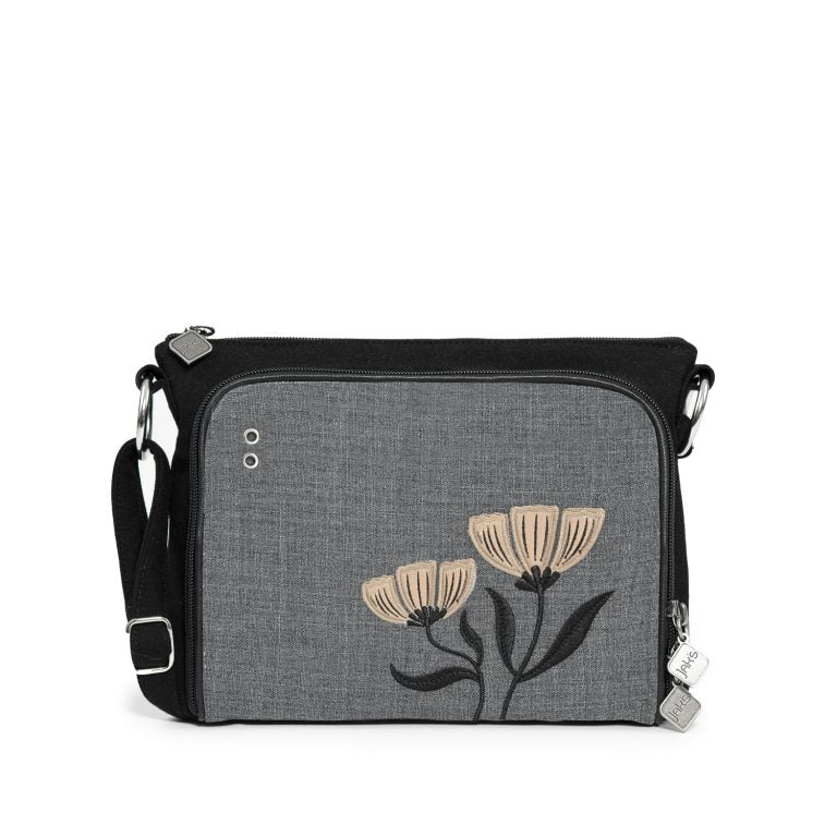 The Jak's Actuelle Baobab shoulder bag in Sand combines elegance with practical design. Featuring exquisite floral embroidery, it adds a touch of charm to any outfit. Its cleverly designed front organizer pocket provides easy access to your cards, coins, and personal items, keeping you organized on the go. Although compact, this bag offers ample space to carry your daily essentials comfortably, making it perfect for both casual outings and special occasions. 
