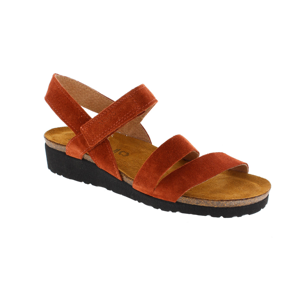 The Naot Kayla strappy sandal brings vibrant orange style to your summer wardrobe. Featuring soft suede upper and footbed, velcro halter strap closures, and a low wedge heel for gentle support. Cork midsole with light arch support and EVA outsole. True-to-size fit for narrow-medium feet.