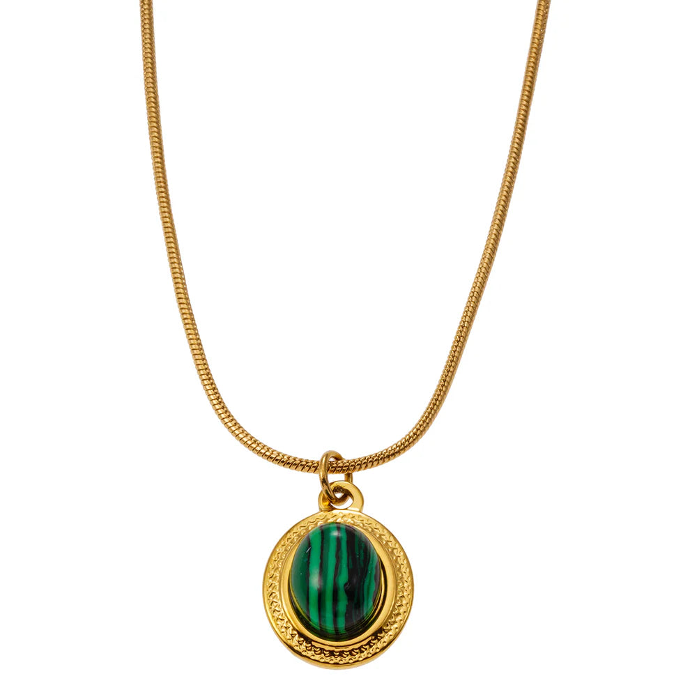 Expertly crafted and delicately designed, the Hackney Nine Kristos necklace is a vintage-inspired piece that brings an elegant touch to any outfit. Featuring a unique malachite stone, known for its natural beauty and deep green hues, encased in an ornate gold setting. Perfect for those who appreciate refined craftsmanship and natural gemstones.