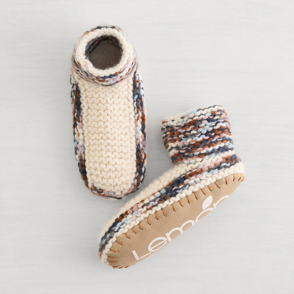 Stay warm and cozy with the Lemon Aurora Bootie Slipper in Ivory. Featuring a plush Berber lining, these booties provide exceptional softness and insulation, making them perfect for chilly, snowy days. Slip into comfort and keep your feet snug no matter the weather.