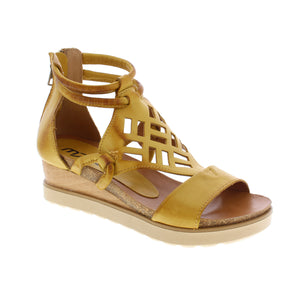 This gladiator wedge sandal boasts a sleek leather upper and includes a sturdy ankle strap and stylish geometric cutouts, making it a versatile choice for both day and evening wear.