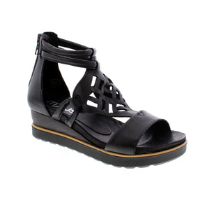 This gladiator wedge sandal boasts a sleek leather upper and includes a sturdy ankle strap and stylish geometric cutouts, making it a versatile choice for both day and evening wear.