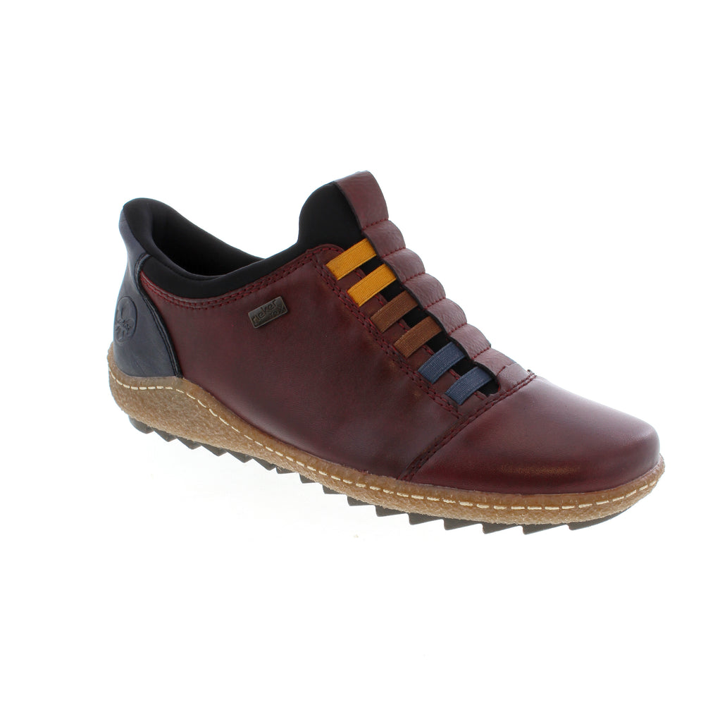 Effortless comfort meets timeless style with the Rieker L7562-35 in rich burgundy. This slip-on shoe features a supple leather upper and supportive rocker bottom sole, designed for all-day ease.&
