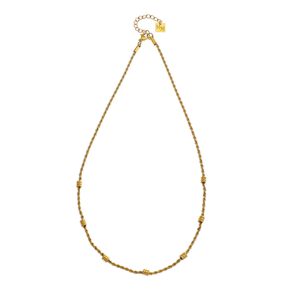  Elevate your style with the Hackney Nine Lemoges Gold necklace. Crafted from premium graded recycled metal and layered in luxurious 18K pure gold, it adds a touch of twinkle to any look. Non-allergic and free of harmful materials, this beaded rope chain is perfect for any occasion.