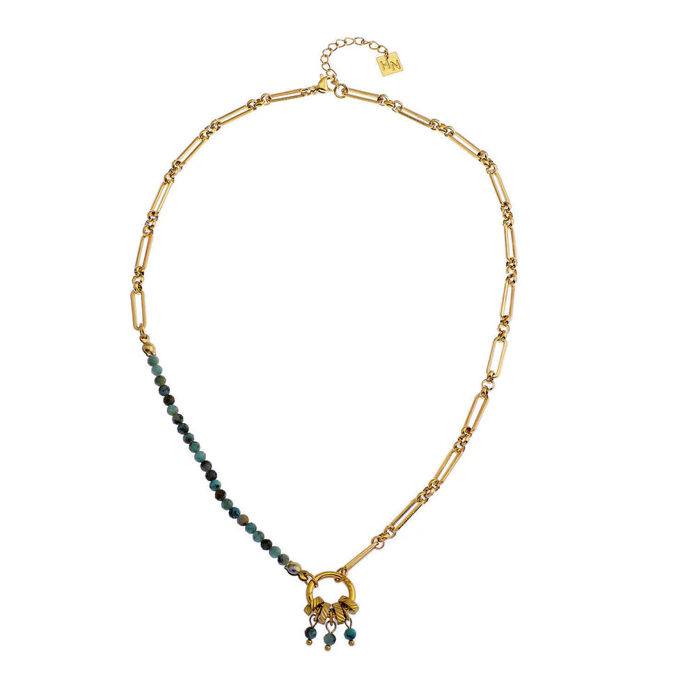 This bohemian necklace features African turquoise natural stones paired with gold-toned beads on a delicate paperclip chain. A charming pendant with playful accents completes the design. African turquoise is traditionally believed to support physical and mental wellness when worn close to the body. Perfect for those drawn to boho-inspired jewelry with meaningful gemstones.