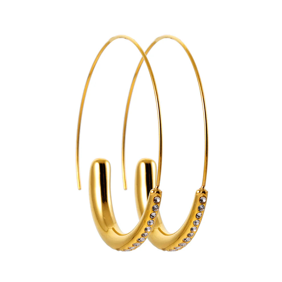 Elevate your style with the Hackney Nine Lyssa Gold earrings. The unique blend of thick and thin, curved shape creates a mesmerizing contrast. Each earring is adorned with carefully embedded zirconia gemstones, adding a touch of brilliance and sparkle to any outfit. Contemporary and timeless, these earrings are a must-have for any fashion-forward individual.