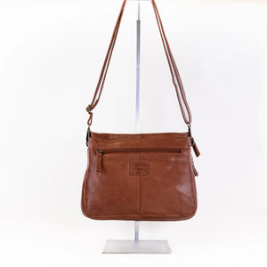 The Milo Bags Cecilia in Cognac is a timelessly stylish leather crossbody bag. Its sturdy design includes two compartments and several pockets to help you stay organized. With spacious storage and a hands-free option, it's an ideal choice for those with a busy, on-the-go lifestyle.