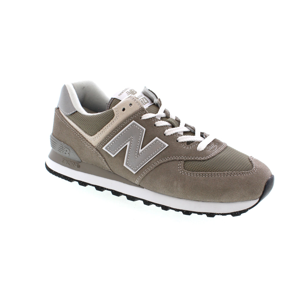 This product, the New Balance ML574EVG in grey, features a combination of upper suede and mesh materials, making it suitable for both casual and athletic occasions. Designed for performance walking and road running, the solid outsole is made of EVA for added durability and comfort. Additionally, the midsole is made of foam and the footbed can be removed, providing orthotic friendly support for men. This shoe is available in grey and black and offers a lace-up closure for a secure fit. 