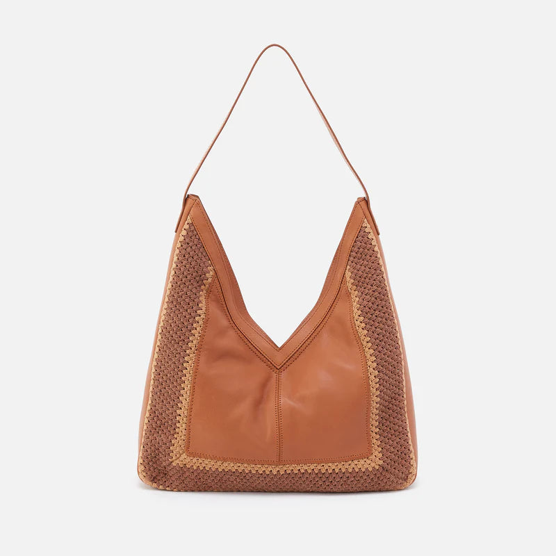 The Hobo Bags Daisy has a leather exterior embellished with crocheting, a convenient top zipper, and is roomy enough to store all your essentials!