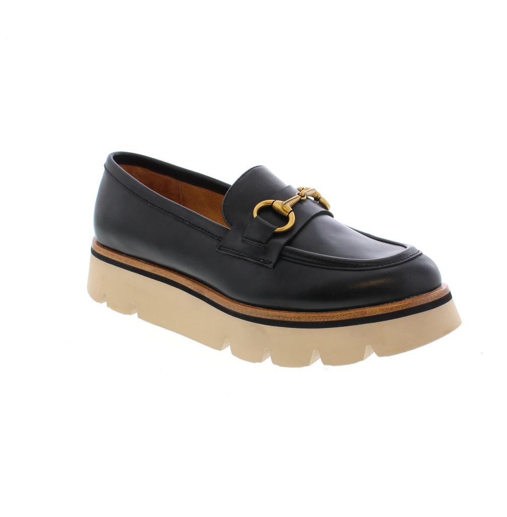 This sophisticated loafer from Tamara London combines modern elegance with everyday wearability. The supple leather upper delivers a refined aesthetic, while the signature metal buckle detail adds a distinctive accent. A cushioned insole ensures sustained comfort throughout the day, whether navigating professional settings or casual outings. The Oppo strikes an ideal balance between polished style and practical functionality for the discerning wearer.