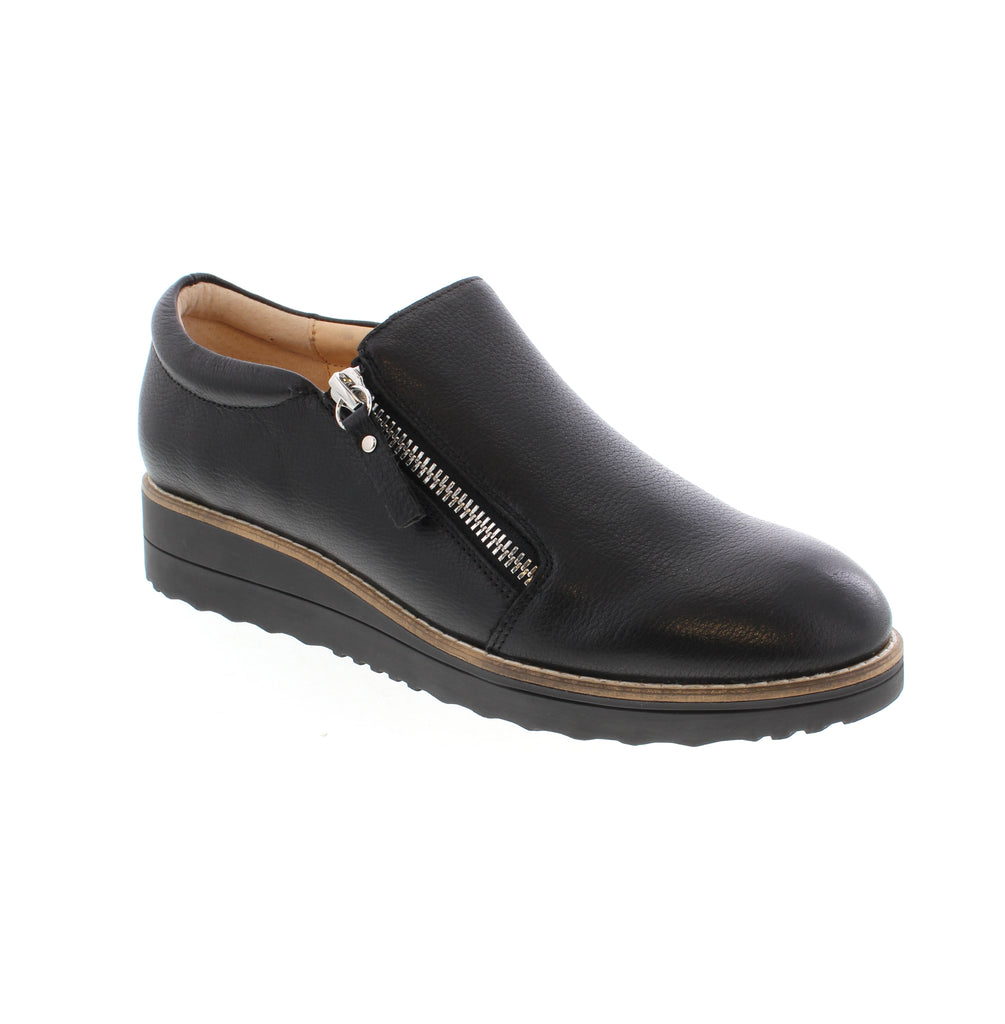 Django &amp; Juliet's Ostel loafer combines timeless style with everyday comfort. This black leather loafer features a round toe, wedge heel, and side zip entry for effortless wear. Crafted with a leather upper and lining, the shoe sits on a foam midsole and rubber outsole for cushioning and durability.