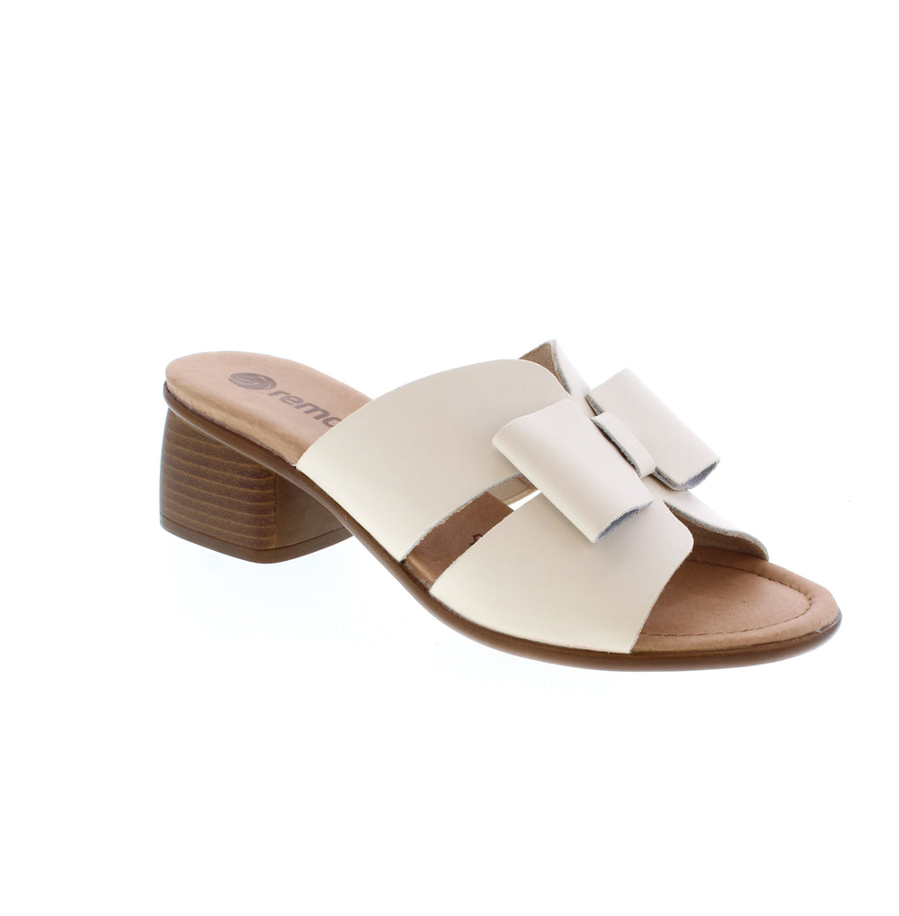 The Remonte R8759-60 is a sleek white slip-on sandal with a leather upper and round toe. Featuring a sturdy block heel and foam midsole, it delivers comfort for casual wear, weddings, and graduations alike.