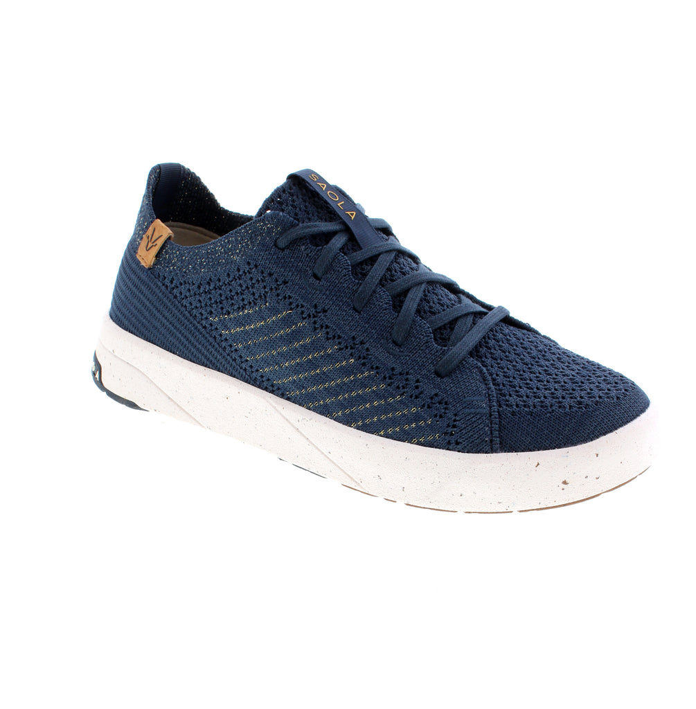The Saola Cannon Knit 3 W SAO5145-228 in navy and gold delivers sustainable comfort with eye-catching style. Featuring a breathable mesh and fabric upper with microfiber lining and a removable insole for orthotics, this vegan-friendly sneaker supports your foot naturally. The shock-absorbent EVA/PU and cork midsole paired with a rubber outsole cushions every step, while the flatform heel and white sole complete the contemporary look.