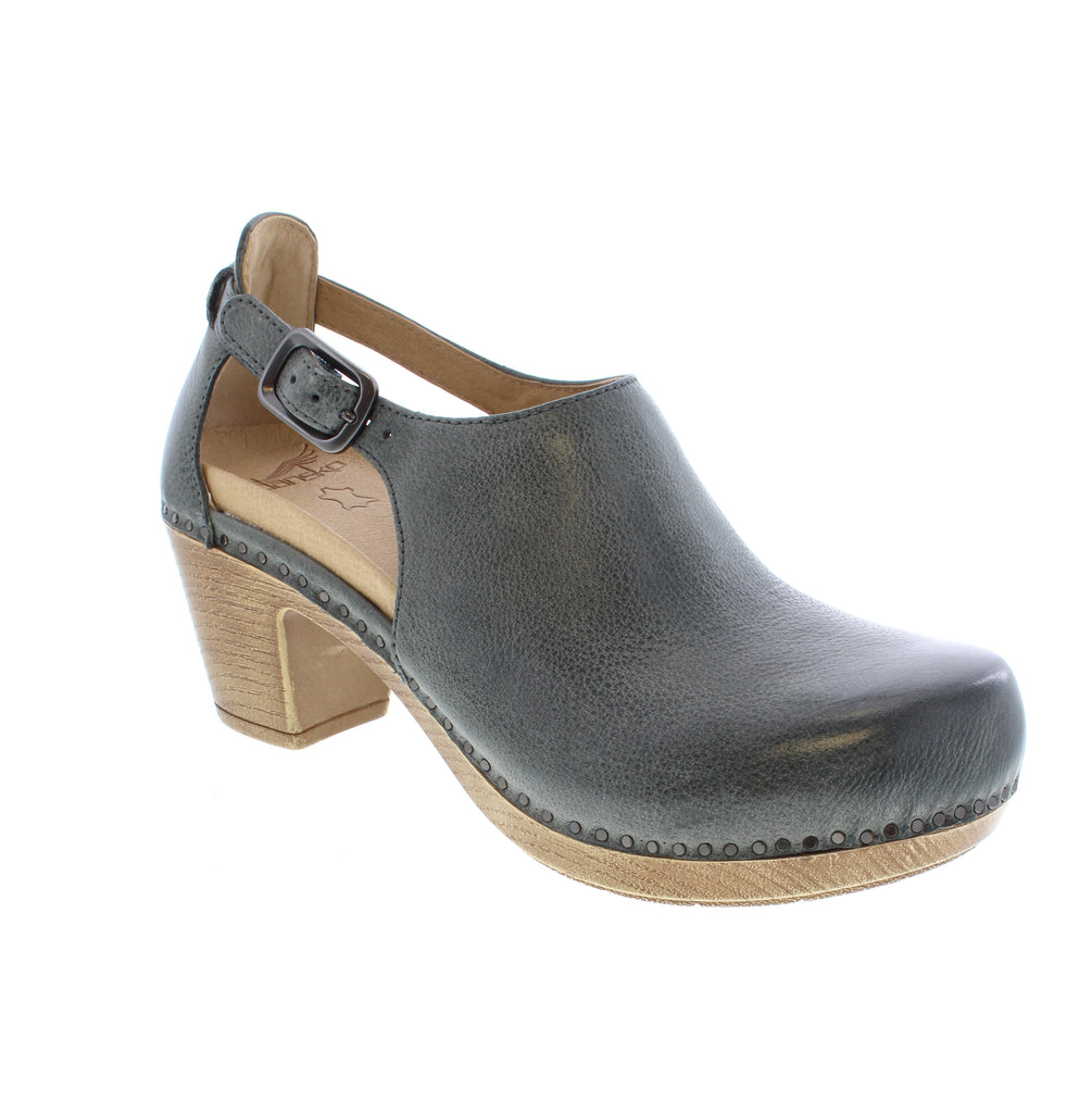 The Dansko Sassy in Slate offers a sophisticated transitional heel ideal for fall. Crafted with high-quality leather featuring a distinctive cutout design, it combines style with breathability. Equipped with Dansko Natural Arch® technology, it delivers precise arch support, ensuring comfort and confidence throughout your day. Perfect for those seeking both elegance and ergonomic support in their footwear.