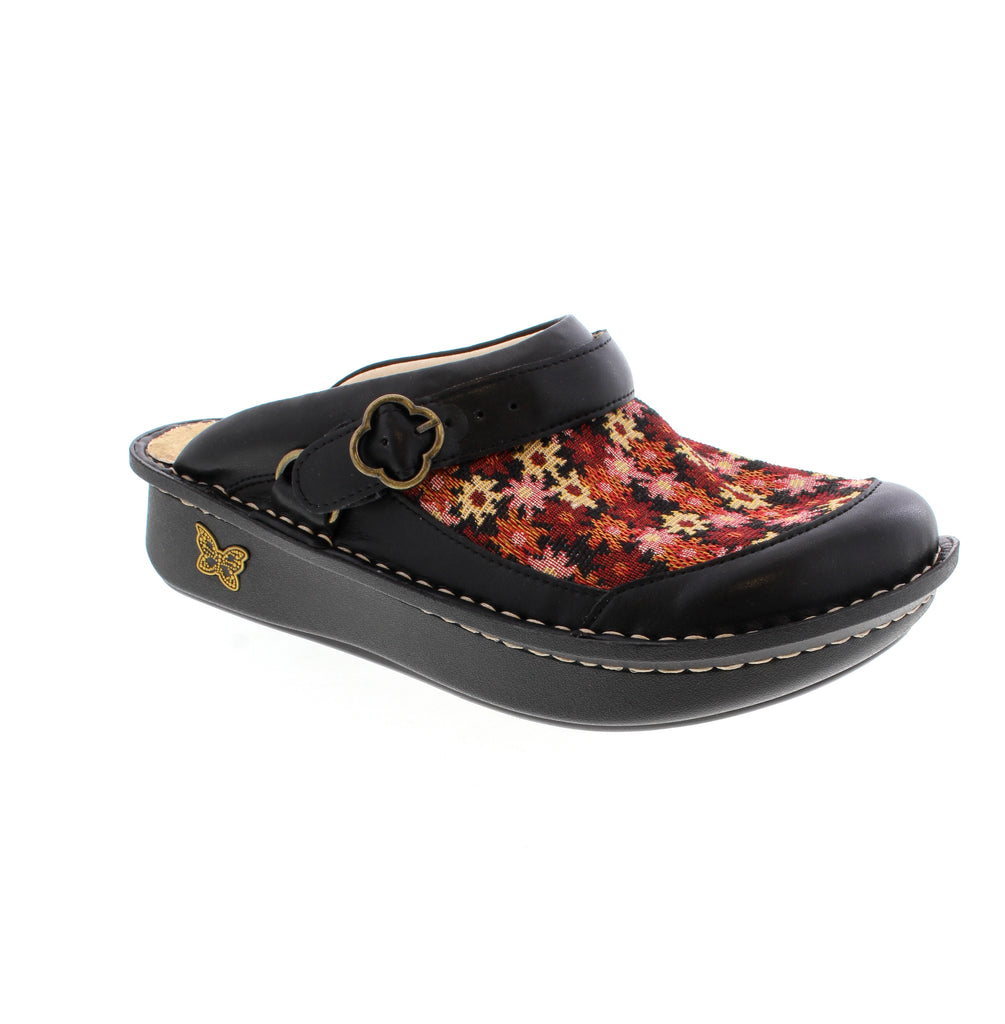 The Alegria Seville clog in Black Print combines professional comfort with everyday style. Crafted from stain-resistant leather with a suede footbed, this orthotic-friendly shoe delivers light arch support for all-day wear. The adjustable swivel strap and rocker bottom outsole provide stability and ease of movement. Hand-stitched construction, slip-resistant sole, and removable insole make it perfect for spring and summer. APMA accepted.