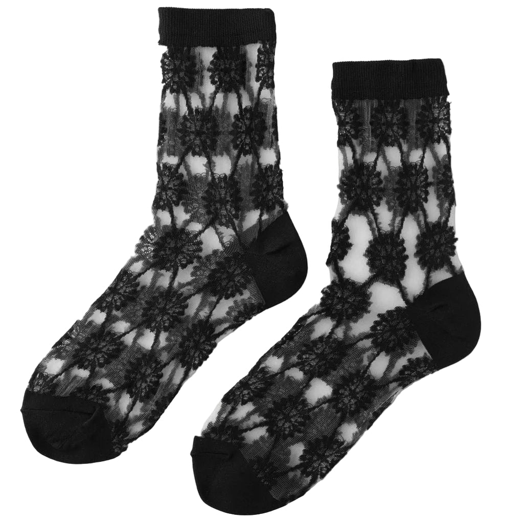 Drawing inspiration from ornate architectural motifs, the Unified Sheer Medallion crew features a rhythmic starburst pattern that feels both geometric and ethereal. This style captures vintage elegance reimagined with clean, modern transparency that plays beautifully against the skin. Lightweight and breathable, this sock serves as an artistic focal point for your footwear adding intricate starburst detail that elevates a simple pump or structured loafer. 