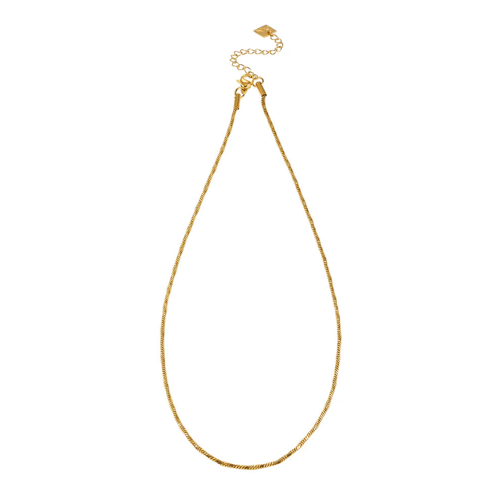Hackney Nine's Skagway necklace is a timeless chain design in luxurious gold. Featuring delicate twisted links that catch the light beautifully, this versatile piece works alone or layered with other jewelry. Crafted from premium 18k gold-infused alloy, it combines understated elegance with thoughtful detail—perfect for those who appreciate quality minimalism.