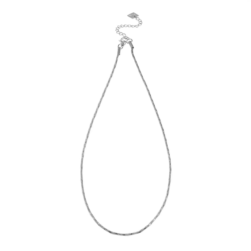Hackney Nine's Skagway necklace is a timeless chain design in luxurious white gold. Featuring delicate twisted links that catch the light beautifully, this versatile piece works alone or layered with other jewelry. Crafted from premium 18k gold-infused alloy, it combines understated elegance with thoughtful detail—perfect for those who appreciate quality minimalism.