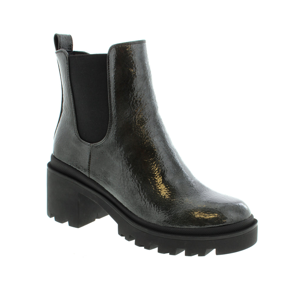 The Aqua Flex Slick One boots in black seamlessly blend style and comfort. Featuring a sleek patent leather upper, these boots add a polished and contemporary touch to any outfit. The side zipper and elastic gore panel provide effortless slip-on convenience, making them easy to wear throughout your busy day. Inside, a cushioned interior ensures lasting comfort, supporting your feet whether you're on the move or standing for long periods. 