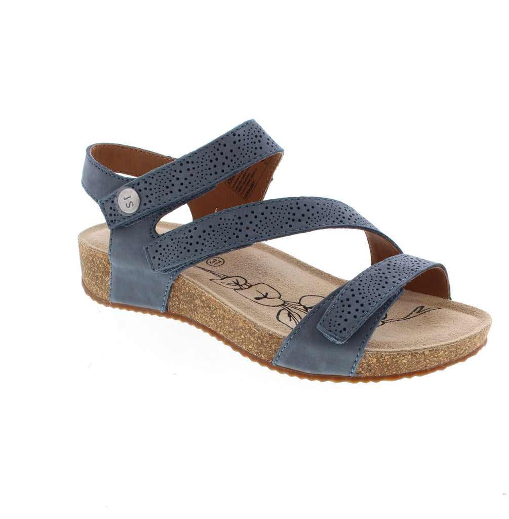 The Josef Seibel Tonga 78 delivers casual comfort in a sophisticated blue palette. Crafted from perforated nubuck, the upper promotes breathability while maintaining durability. The microfiber footbed provides a soft surface underfoot, while the cork midsole offers natural shock absorption. A subtle wedge heel and light arch support work together to reduce strain during everyday wear. The velcro closure ensures easy on-and-off convenience.