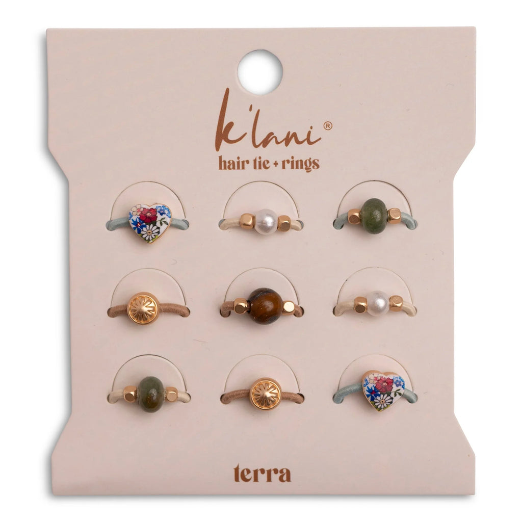 The K'lani Terra hair tie rings combine style and function in one versatile pack. This set of 9 stretchy rings work as finger rings or hair ties, perfect for securing small sections or braids. Warm neutral tones with gold accents, pearls, and earthy stones look beautiful stacked or worn in your hair.