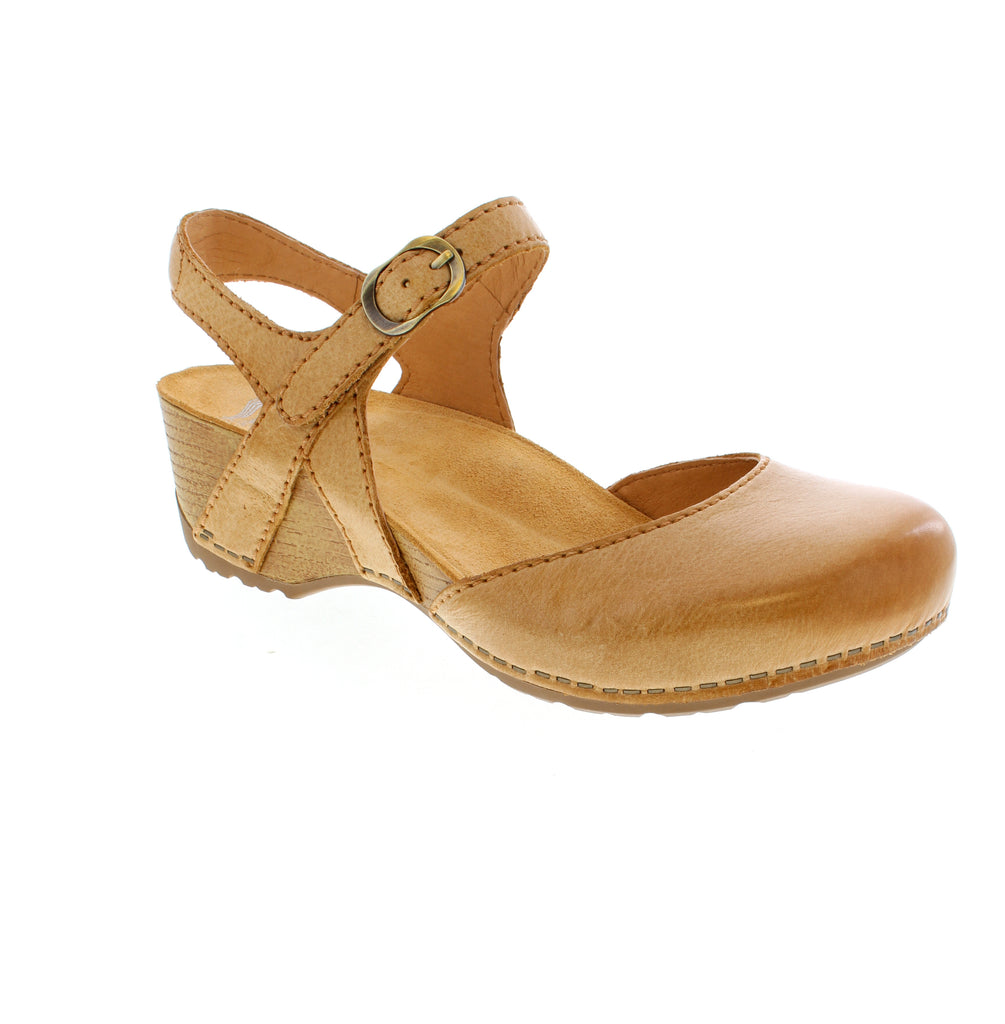 Step into effortless style with the Dansko Tiffani in Tan—a Mary Jane flat that's as comfortable as it is chic. Featuring a supple leather upper, cushioned suede footbed, and a sturdy rubber outsole, this European-sized shoe keeps you supported through office meetings and weekend adventures alike. The buckle closure adds a touch of vintage charm, while the block heel provides just enough lift without sacrificing comfort.