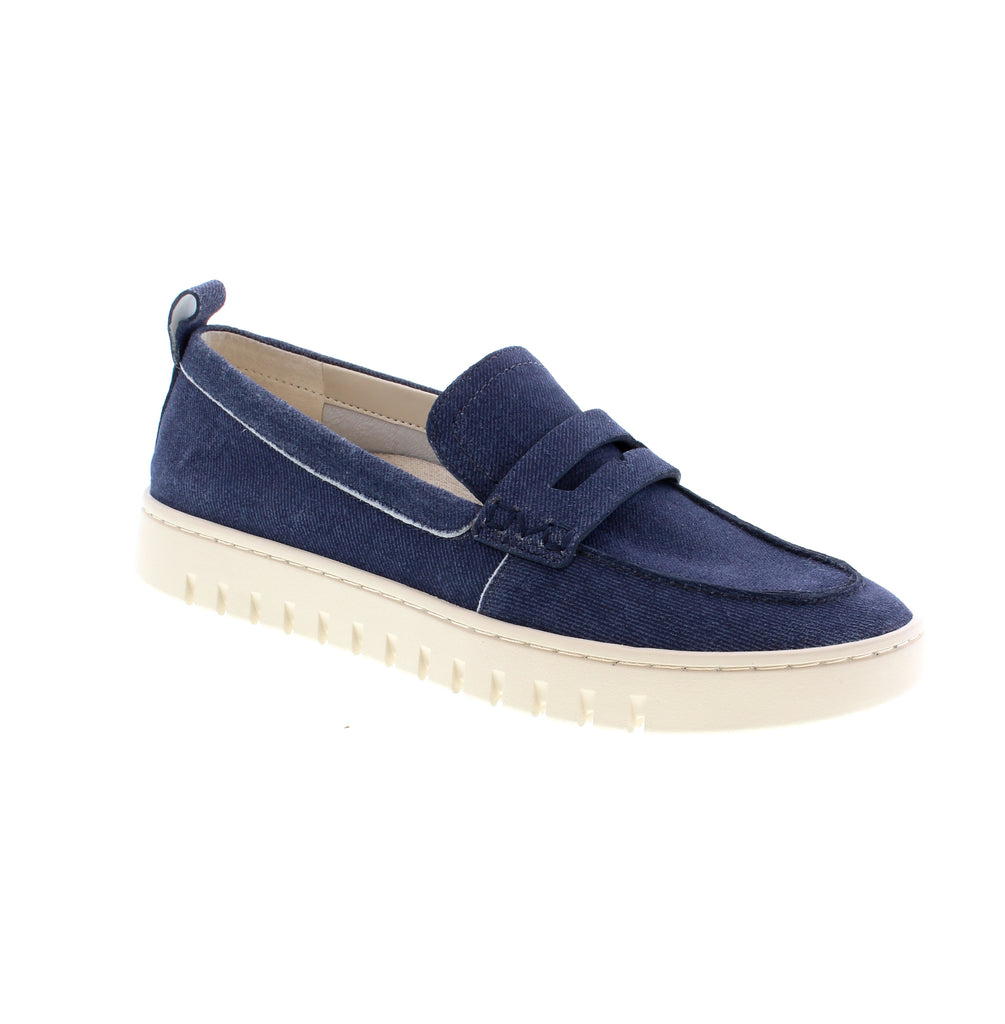 The Vionic Uptown in Dark Denim combines timeless loafer styling with podiatrist-designed arch support. Crafted from premium denim uppers with a leather-reinforced toe, this slip-on flat features a removable microfiber insole and EVA/PU midsole for all-day comfort. The flexible rubber outsole and less-than-1" heel make it ideal for casual wear, while the almond toe shape flatters most foot types. 