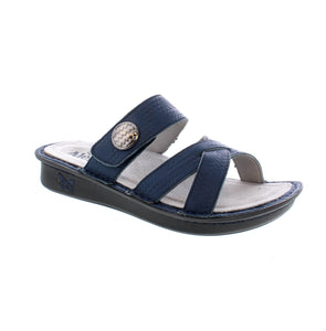 The Victoriah sandal features criss-cross straps and adjustable velcro closure for the perfect fit. A mini rocker outsole with superior arch support, a leather lining and insole, and a removable and replaceable footbed keep your feet feeling great with every step!