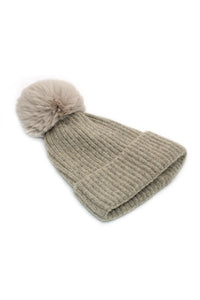 Stay warm and stylish with the Morgan & Taylor Romy Beanie in Taupe. Its distinctive vertical cable knit design adds texture while the extra large pompom provides a soft, statement touch. Perfect for any winter outfit, this beanie is a must-have for the season.