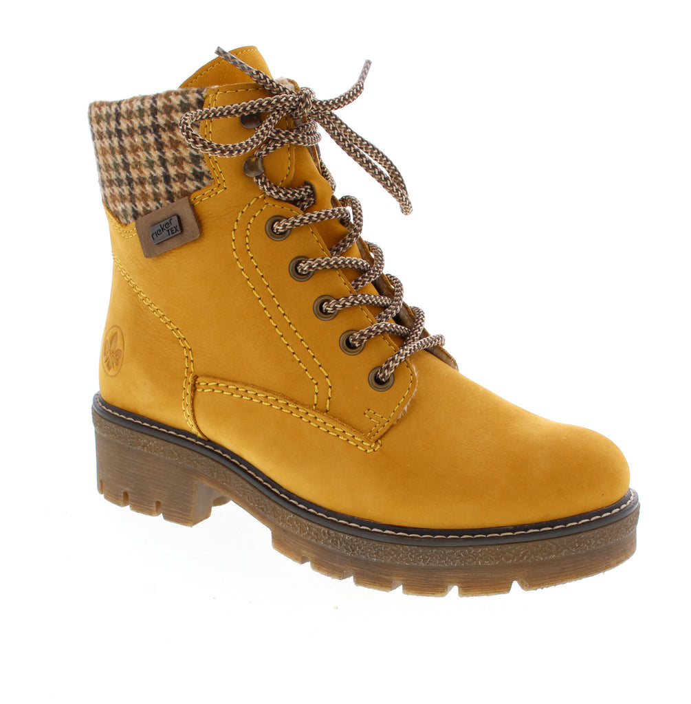Brighten your winter wardrobe with the Rieker Y8130-68 in cheerful yellow. This versatile ankle boot combines casual style with practical outdoor performance, perfect for cold-weather adventures. Nubuck upper with water-resistant protection keeps feet dry and comfortable. Fleece lining and insulation provide warmth, while the foam midsole and shock-absorbent rubber outsole deliver all-day support.