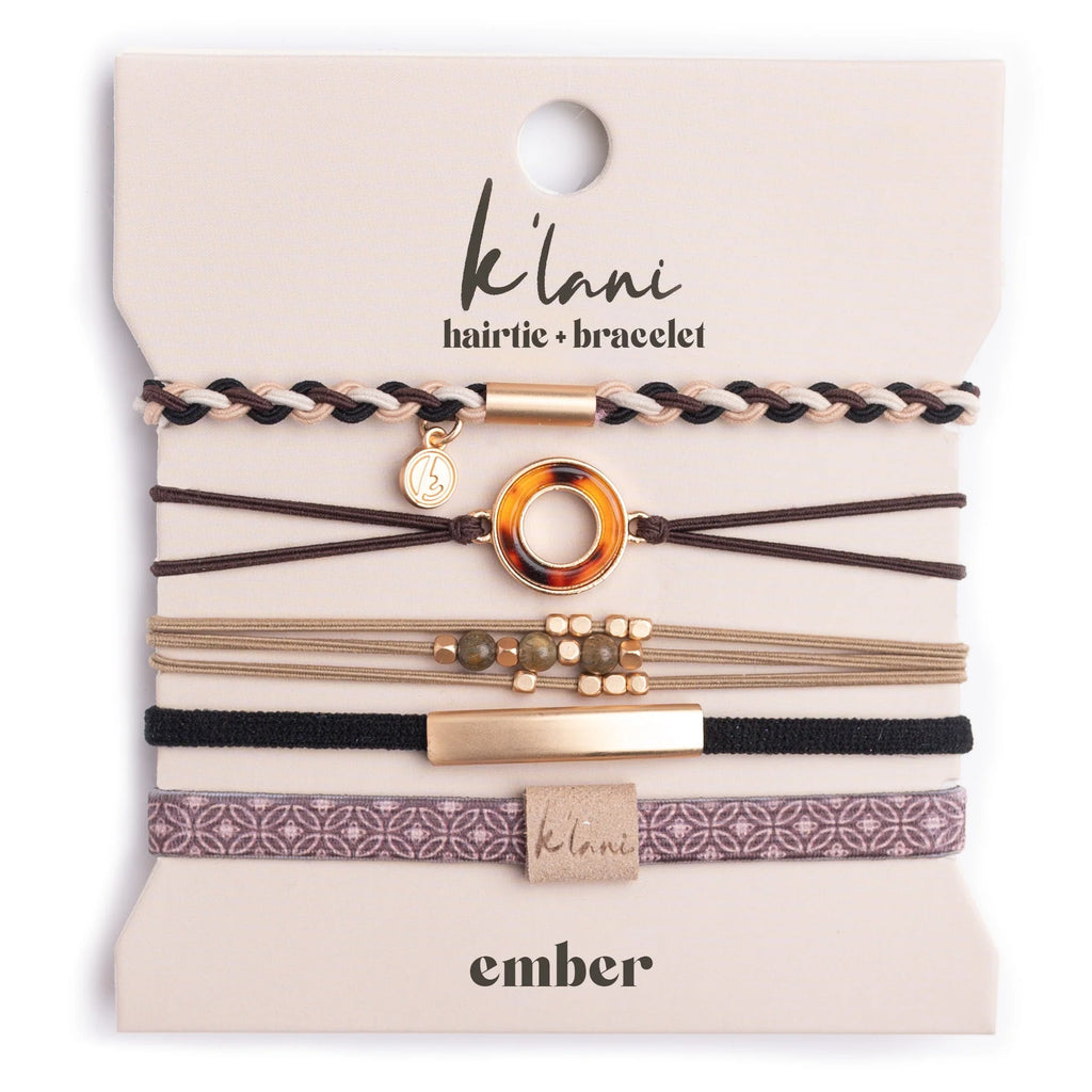 The K'lani Ember collection brings together five hair tie bracelets in warm, neutral hues that capture the essence of effortless elegance. Crafted with soft tans and deep brown tones, each piece pairs beautifully with a classic tortoise shell ring charm for a polished, timeless finish. Perfect for those who appreciate understated sophistication, this versatile set transitions seamlessly from day to evening, offering the ideal blend of comfort and refined style for any occasion.