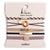 The K'lani Ember collection brings together five hair tie bracelets in warm, neutral hues that capture the essence of effortless elegance. Crafted with soft tans and deep brown tones, each piece pairs beautifully with a classic tortoise shell ring charm for a polished, timeless finish. Perfect for those who appreciate understated sophistication, this versatile set transitions seamlessly from day to evening, offering the ideal blend of comfort and refined style for any occasion.