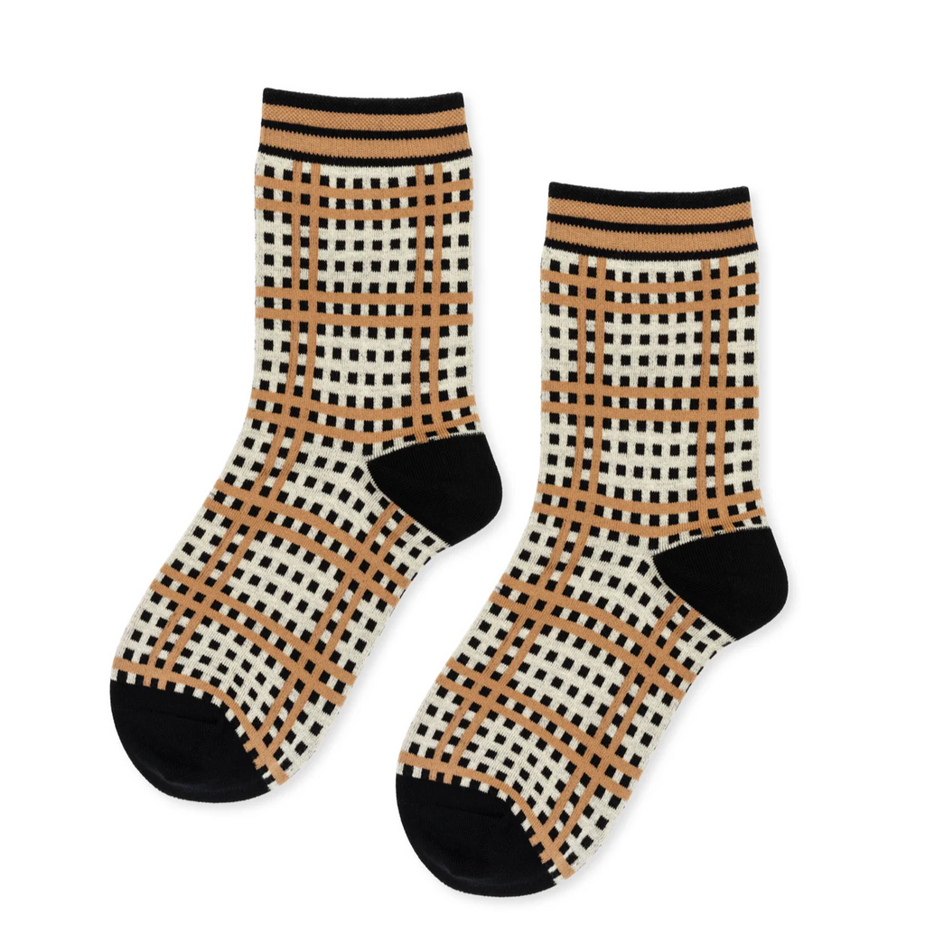 Hansel From Basel Mad For Plaid Crew Socks in Black reinvent classic plaid with a modern, grid-inspired design that adds a fresh, playful edge. These socks bring a bold yet sophisticated look, perfect for anyone wanting to elevate their style beyond the ordinary. Crafted with attention to comfort and durability, they ensure all-day wearability while making a distinctive fashion statement. Step out with confidence and showcase your unique personality through a timeless pattern with a contemporary twist.
