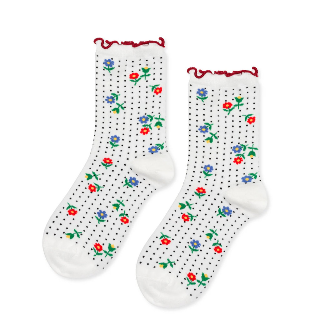 The Hansel From Basel Dottie Floral Crew Sock in White brings a fresh, vibrant touch to your outfit with its charming cotton floral pattern that stands out beautifully against a delicate dotted background. Designed with a unique contrast-stitched lettuce cuff, these socks add a playful, stylish edge to your look. Perfect for adding a pop of personality, they keep your feet comfortable and fashionable all day long, making them a must-have accessory for anyone who loves to blend classic and whimsical styles. 