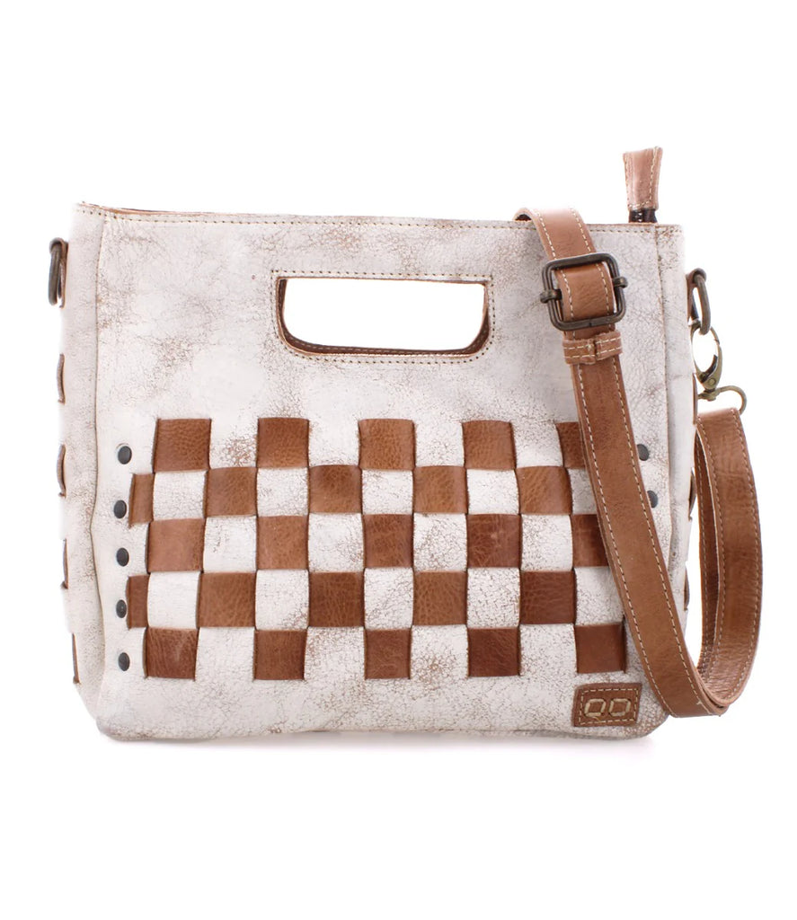 Introducing Keiki by Bed Stu. The woven checkerboard panels create a playful statement. The adjustable removeable crossbody strap offers versatile wear and the zip-top closure keeps essentials secure.