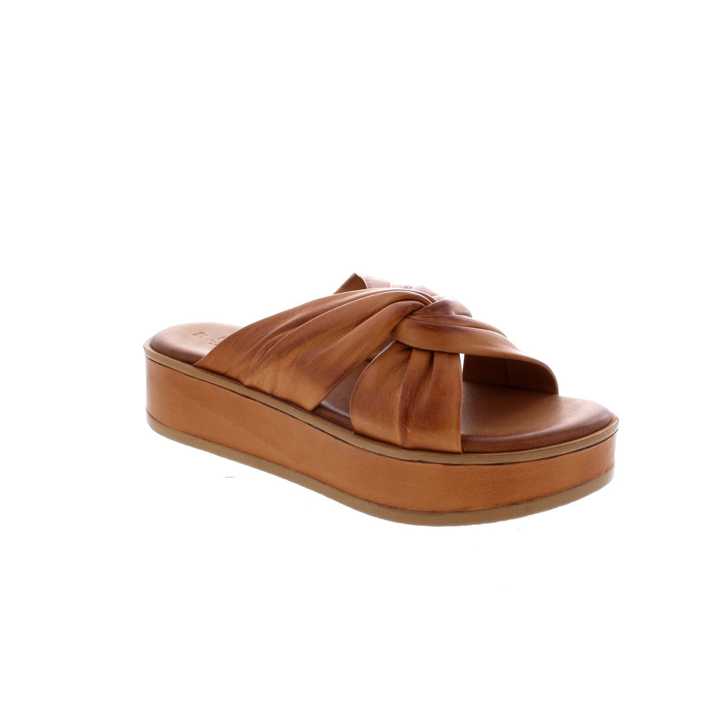 This flatform slide sandal is wrapped in leather with beautiful ruching and knot detailing to keep your feet looking their best! 