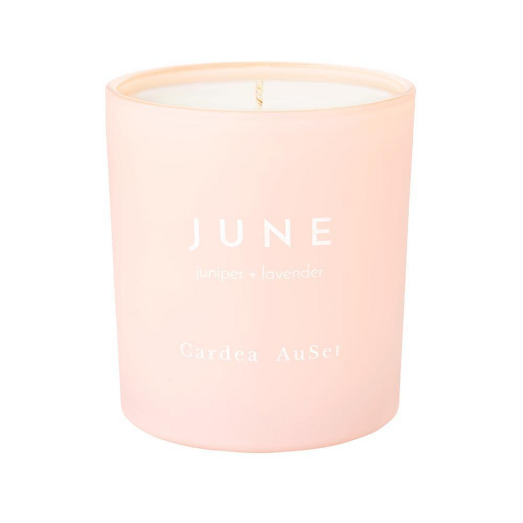 The June Candle is a fresh blend of juniper berry and lavender. This candle is hand-poured and crafted with natural, GMO-free soy and essential oils. Framed in a beautiful pale pink glass with hand-stamped white text, the 7 oz candle is the perfect natural addition to your home.  