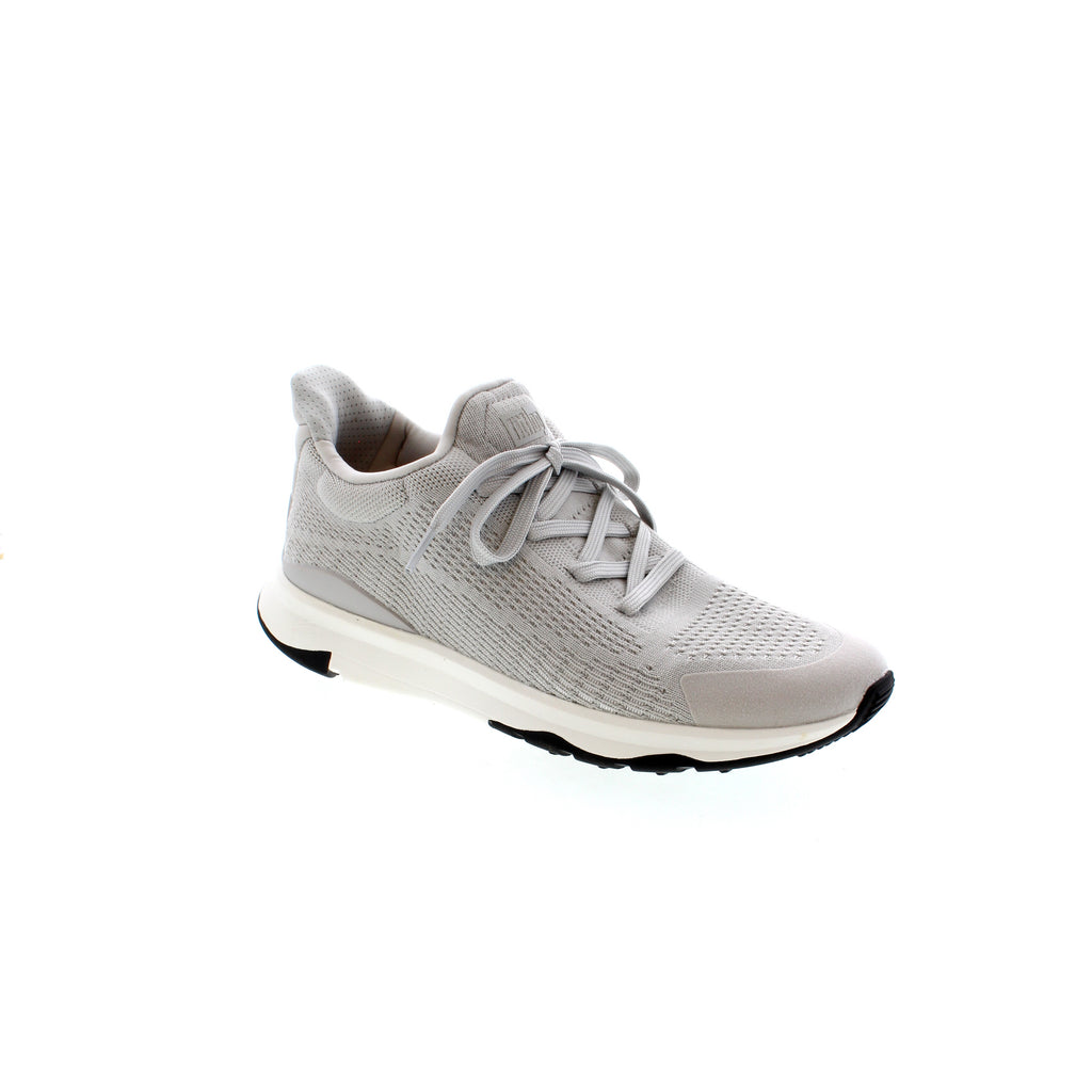 The FitFlop Vitamin FFX Knit Sneaker is designed with comfort in mind, featuring an upper construction of polyester, nylon, and mesh for breathability and support. With a closed toe, light arch support, and a rubber outsole, this versatile sneaker is perfect for a variety of occasions, from casual to athletic.