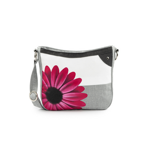 Jak's Tonique Lisbonne flower crossbody features a beautiful, bold flower design, adjustable strap and zippered pocket to keep your valuables safe. 