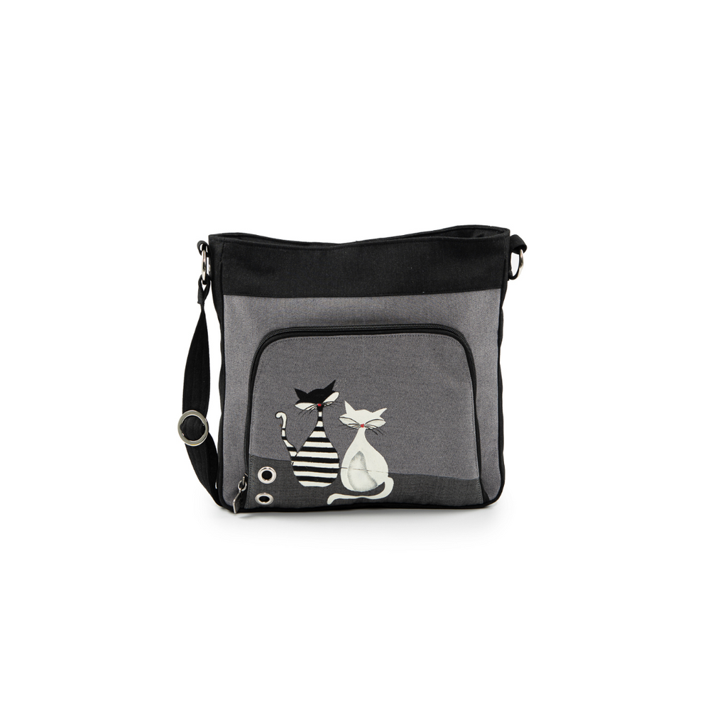 Jak's Tonique Francfort brings just the right amount of charm with a hand-painted cat design, adjustable strap, ring details, zippered pockets to keep you sorted while you're on the go!