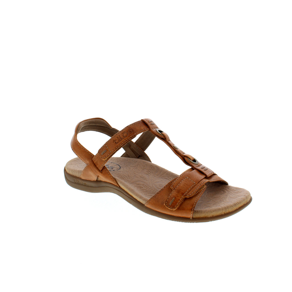 The Taos Swifty T-strap sandal is crafted from soft leather and showcases metal rivet details. Featuring a Soft Support™ premium footbed with extra cushioning, arch and metatarsal support to give your feet ultimate comfort, and a lightweight, rubber outsole to take you wherever you need to go.
