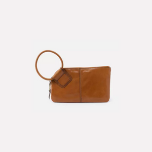 The Sable clutch is designed with a circular handle for a fun, functional way to store your belongings fashionably.